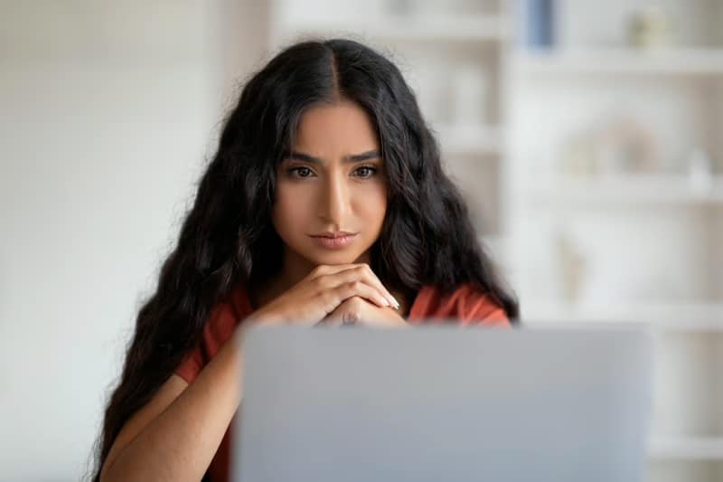Professional building a personal brand by developing an online presence and personal branding strategy on a laptop